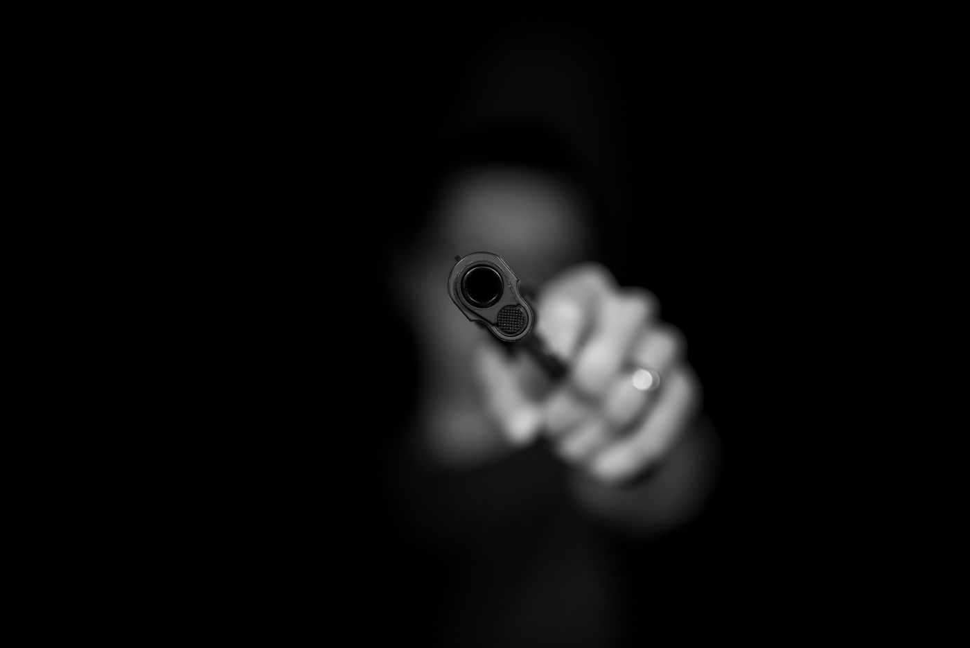black and white picture of person holding a gun