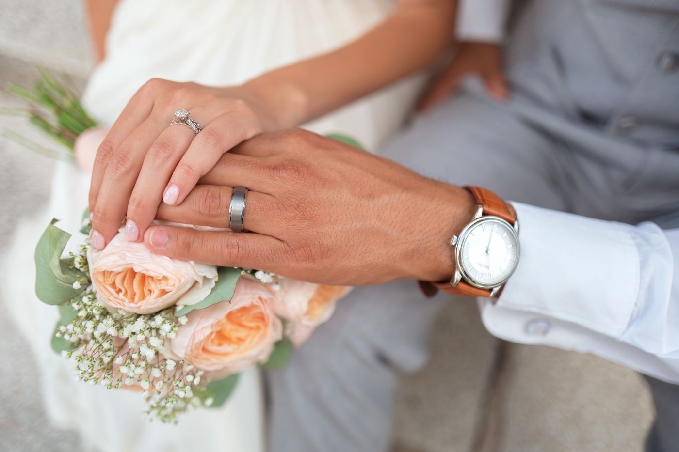 Man and Woman holding hands on flowers