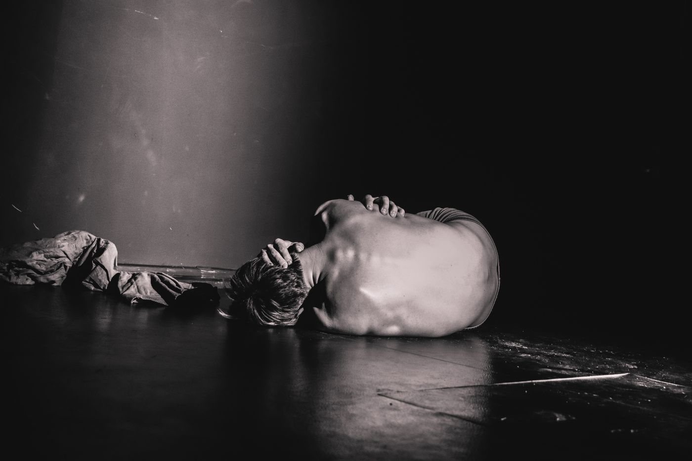 black and white picture of person lying naked on ground