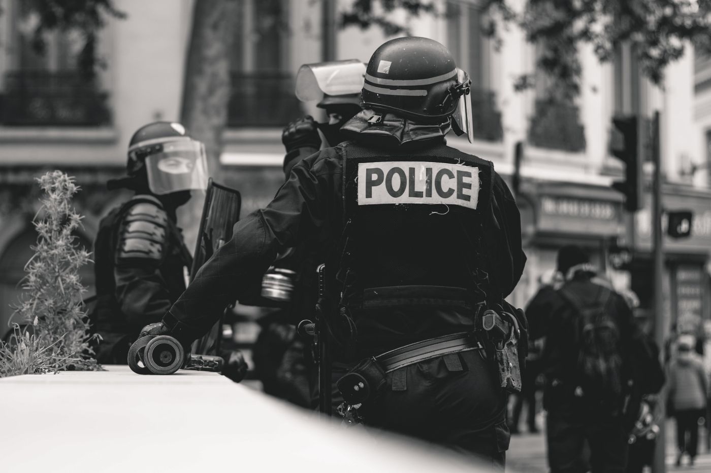 black and white photo of police in riot gear