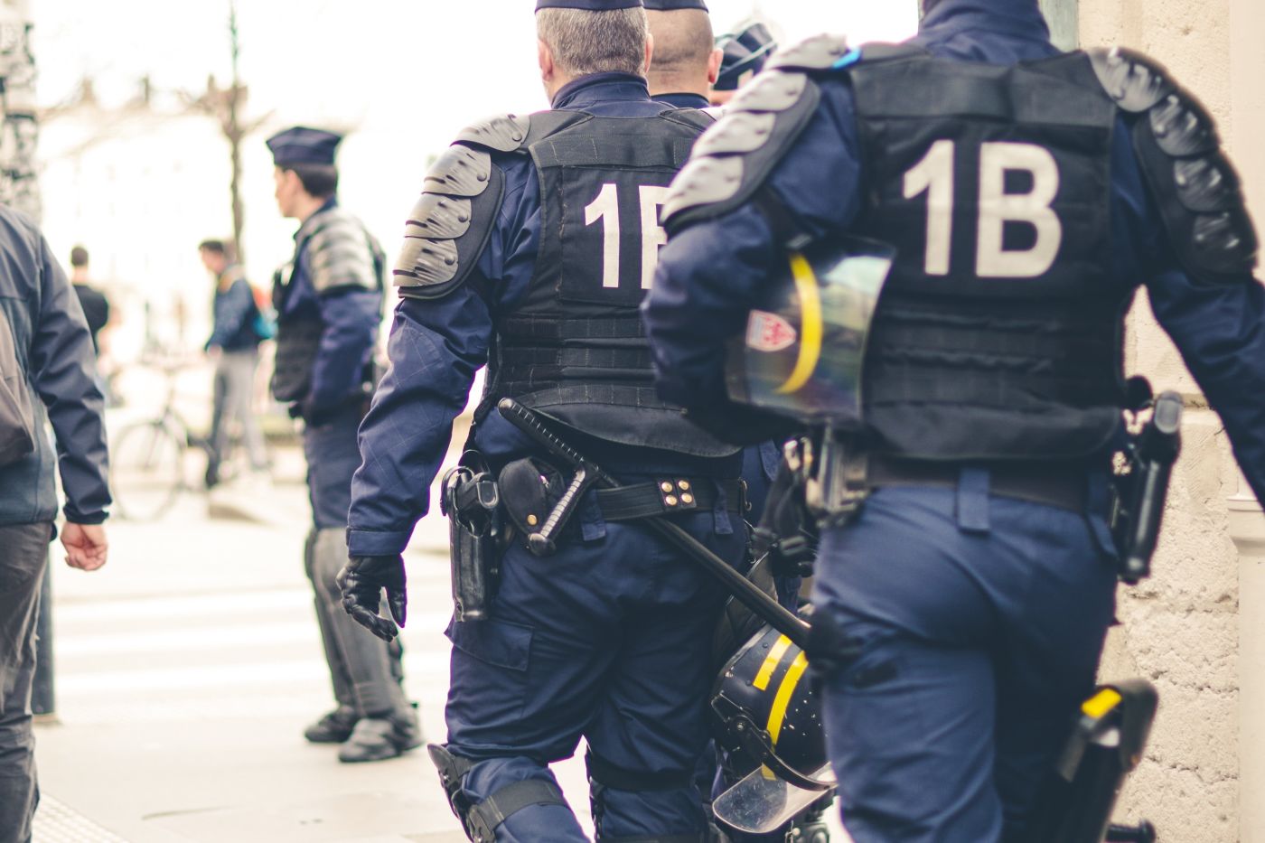 police walking down the street in heavy gear