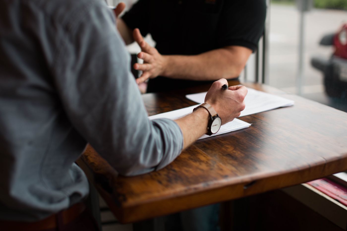 Two people at desk with paperwork