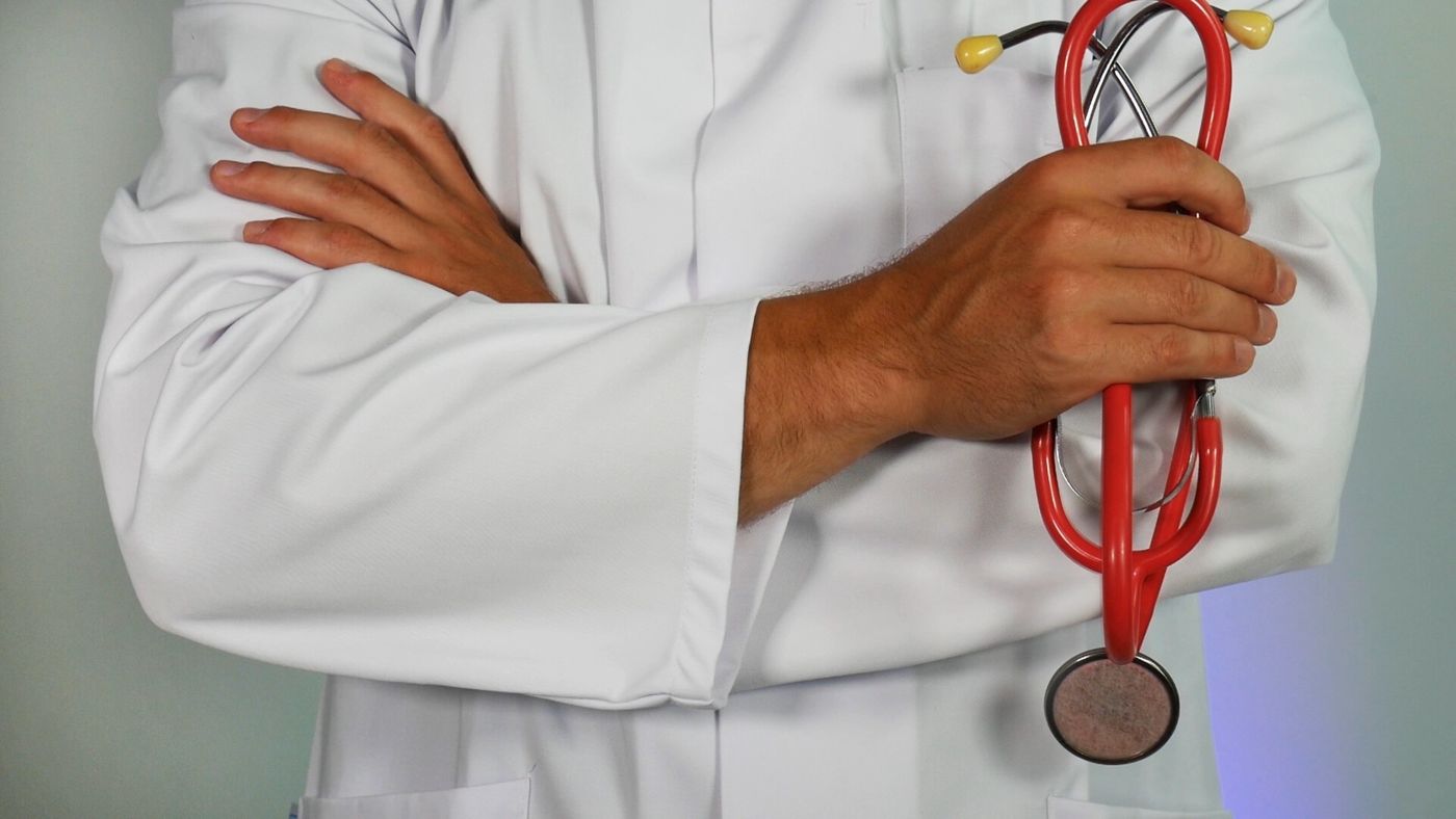 doctor in uniform holding a stethoscope