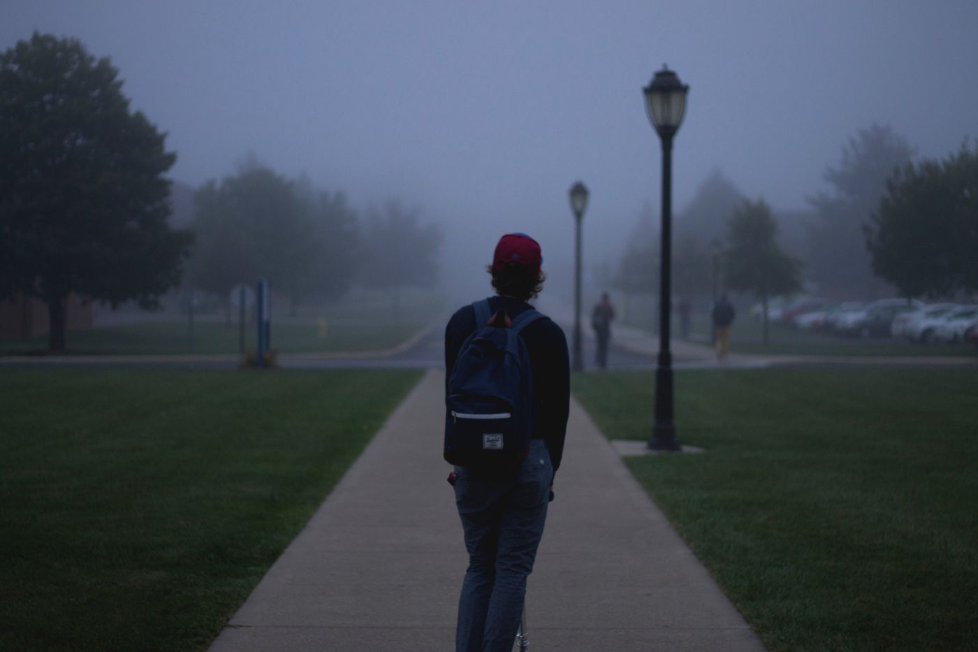college student walking through fog on campus