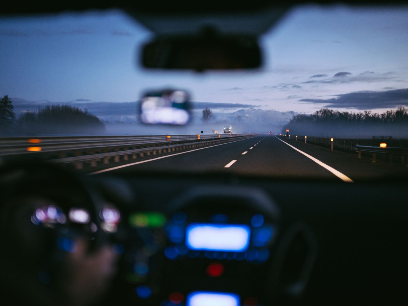 in-car point of view going down highway at night